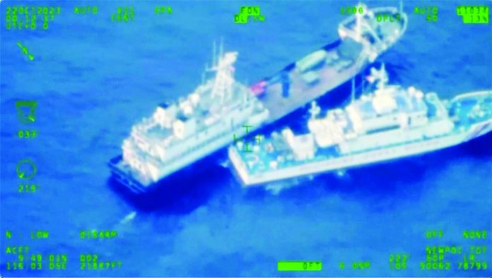 THIS IMAGE released by the Armed Forces of the Philippines shows a Chinese militia vessel (top) and Philippine coast guard vessel BRP Cabra as they approach Second Thomas Shoal, locally called Ayungin Shoal, at the disputed South China Sea on Sunday, Oct. 22, 2023. Armed Forces of the Philippines via AP