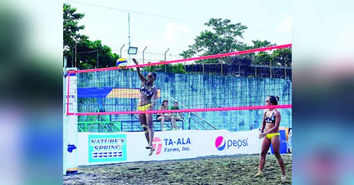 University of Santo Tomas Golden Tigresses’ Genesa Eslapor and Sophia Pagara in action during the 1st Mayor Albee Benitez Beach Volleyball Tournament. PHOTO COURTESY OF PAUL JAN DOLOIRAS