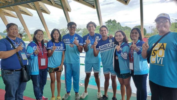 Members of the West Visayas State University swimming team, along with their coaches and school officials. PHOTO COURTESY OF RICHARD GABAYOYO