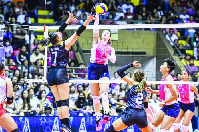 Creamline Cool Smashers’ Michele Gumabao goes for a drop shot against the defense of Cignal HD Spikers’ Frances Xinia Molina. PVL PHOTO