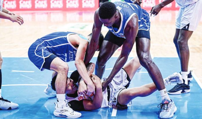 University of the Philippines Fighting Maroons’ Gerry Abadiano protects the ball from fellow Ilonggo Ian Espinosa and Joseph Obasa of Ateneo de Manila University Blue Eagles. UAAP PHOTO