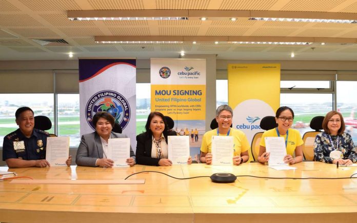 Officials from Cebu Pacific, United Filipino Global, Department of Migrant Workers, Overseas Workers Welfare Administration, and Philippine National Police pose for a photo after the MOU signing. (From L-R) Police Lieutenant General Rhodel Sermonia, Deputy Chief Administrator of the Philippine National Police; Atty. Patricia Yvonne Caunan, Undersecretary of the Department of Migrant Workers; Gemma Sotto, President of United Filipino Global; Xander Lao, CEB President and Chief Commercial Officer; Candice Iyog, CEB Chief Marketing and Customer Experience Officer; Director Rosalia Catapang of the Overseas Workers Welfare Administration.