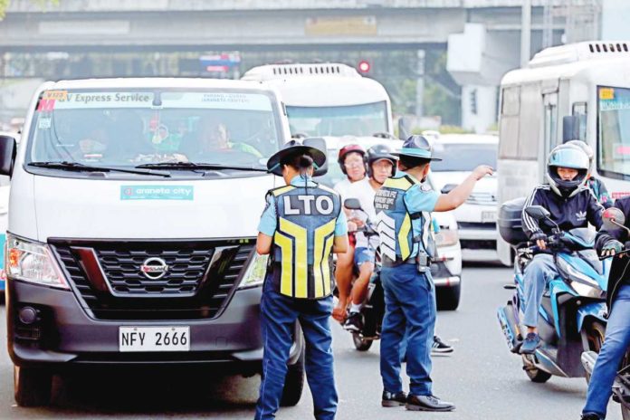 Personnel of the central office of the Land Transportation Office (LTO) conduct an operation against “colorum” or unregistered public utility vehicles, along Aurora Boulevard in Quezon City. LTO says transport groups have complained of losing 30 percent of their income due to these colorum vehicles. PNA