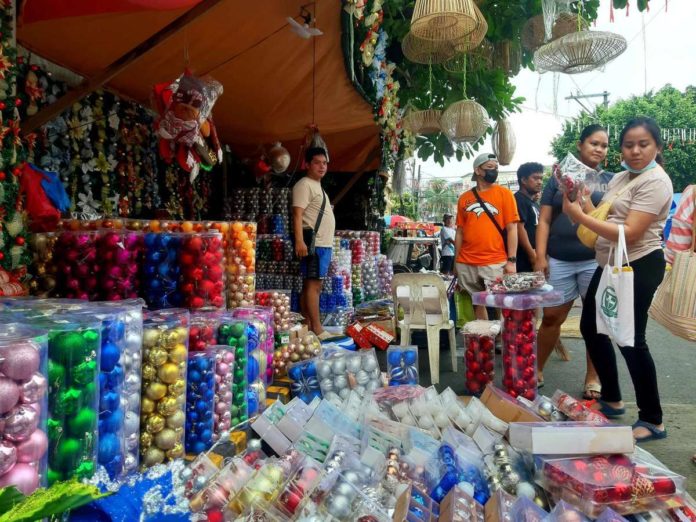 The Department of Labor and Employment reminds employers to release the 13th month pay of qualified employees in the private sector on or before Dec. 24, 2023. Photo shows people buying Christmas decorations as early as October this year. CONTRIBUTED PHOTO