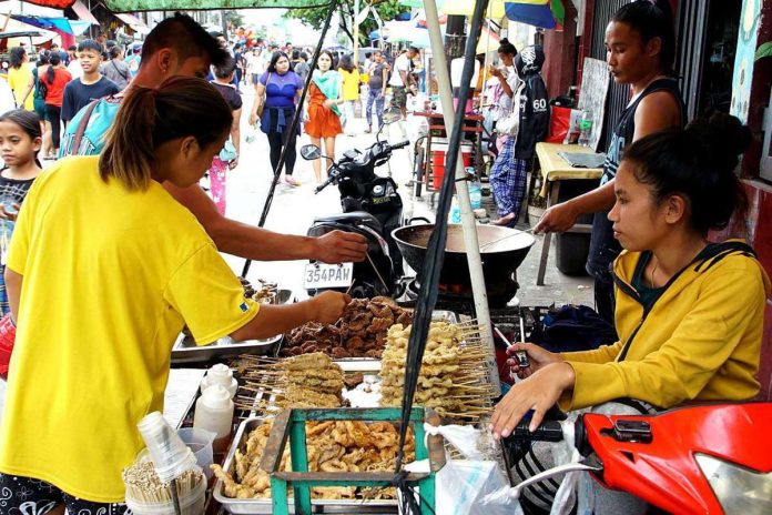 Customers choose from an array of crispy grilled street food along Mayon Street in Bagong Silang, Caloocan City. From January to October, average inflation soared above the government’s 2 to 4 percent target at 6.4 percent and is hitting the economy where it hurts the most: consumer spending. PNA