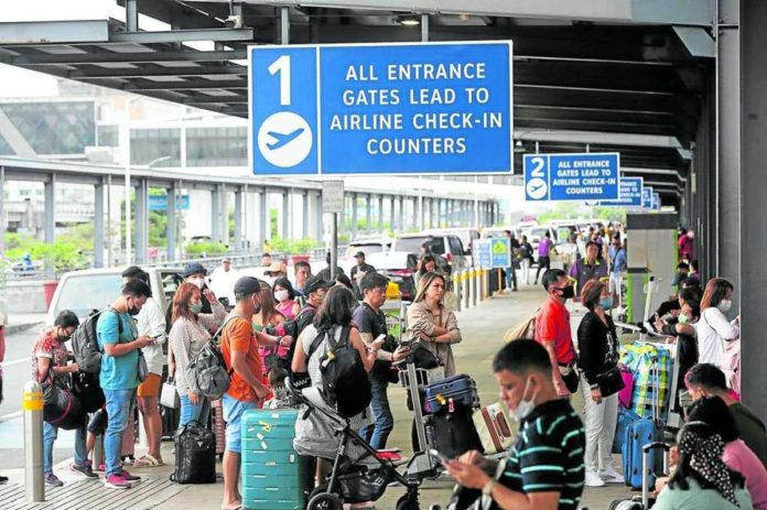 For Level 7, airline passengers will pay a fuel surcharge of P219 to P739 for domestic flights and P722.71 to P5,373.69 for international flights. Photo shows passengers lining up at the departure area of Ninoy Aquino International Airport. INQUIRER FILE PHOTO