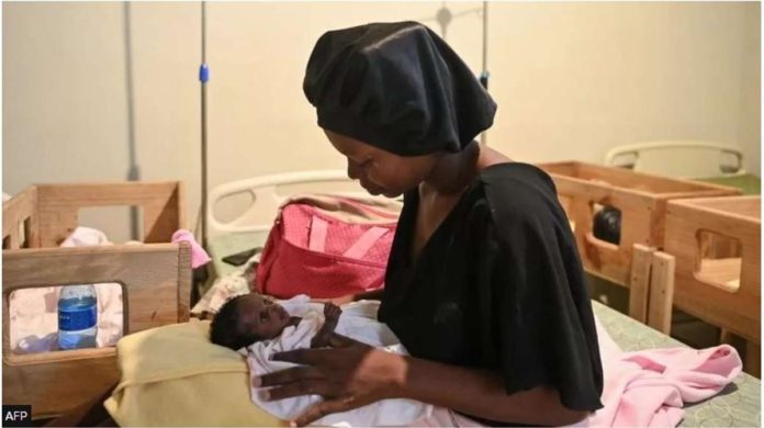 A woman holds a malnourished baby at Fontaine Hospital Center, a community clinic in the impoverished Port-au-Prince shantytown of Cite Soleil. AFP