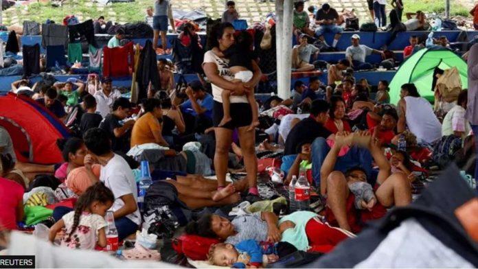 Migrants traveling in a caravan rest before continuing their journey through Mexico in an attempt to reach the USborder, in Huixtla, Mexico. REUTERS