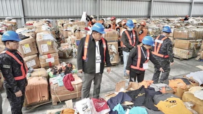 The Bureau of Customs-Port of Subic discovered 1,269 boxes of counterfeit products bearing trademarks and copyrighted materials without authorization from the rights holders. Photo shows Customs commissioner Bienvenido Rubio (second from left) with Port of Subic district collector Carmelita Talusan (third from left) inspecting the seized goods. BOC PHOTO