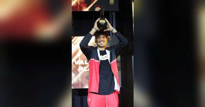 June Mar Fajardo of San Miguel Beermen raises his seventh PBA MVP trophy. PBA PHOTO