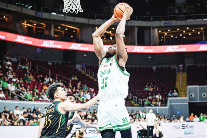 De La Salle University Green Archers’ Bright Nwankwo attempts a two-handed dunk against a Far Eastern University Tamaraws defender. UAAP PHOTO