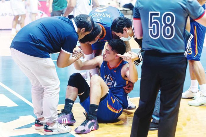 Kevin Alas is assisted by members of the NLEX Road Warriors following a knee injury during their game against Terrafirma Dyip. PHOTO COURTESY OF NLEX ROAD WARRIORS