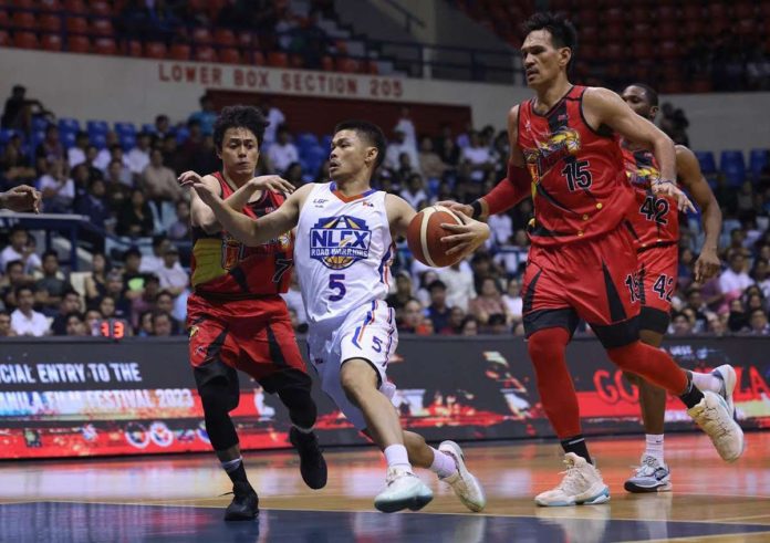 Aklanon Kris Rosales of NLEX Road Warriors tries to elude the defense of San Miguel Beermen’s Terrence Romeo. PBA PHOTO