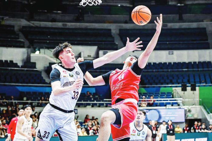 University of the Philippines Fighting Maroons’ Sean Alter foils the shot of University of the East Red Warriors’ Ethan Galang. UAAP PHOTO