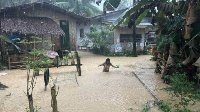 A girl wades through waist-deep floodwater in her village in Prosperidad town, Agusan del Sur, on Monday, Dec. 18., 2023, after heavy rains dumped by Tropical Storm “Kabayan” submerged roads and houses in the community, displacing hundreds of residents. Photo by ERWIN MASCARIÑAS / Inquirer Mindanao