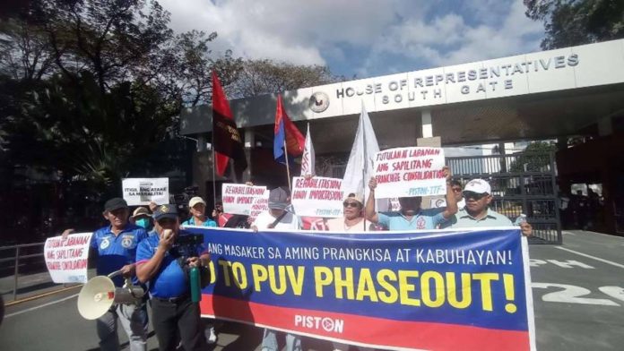 Operators and drivers of traditional jeepneys protest outside the House of Representatives. They are calling for the voiding of the Dec. 31, 2023 deadline given to them to consolidate their franchises. PHOTO BY THE PHILIPPINE DAILY INQUIRER