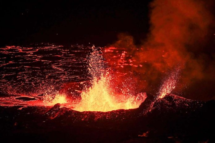 A volcano erupts in Iceland. From its vent can be seen magma flowing out. BBC