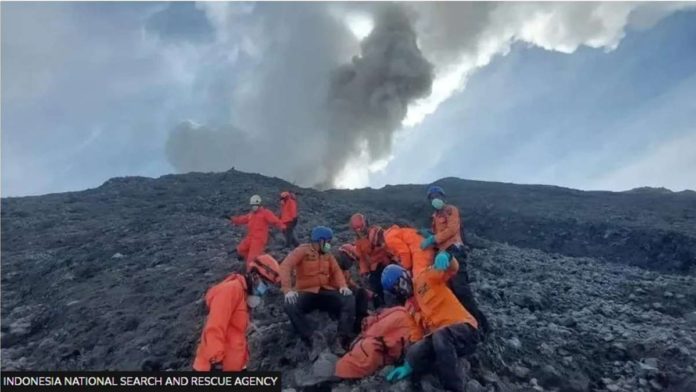 Rescuers brave an erupting Mount Marapi and the slippery terrain. PHOTO BY THE INDONESIA NATIONAL SEARCH AND RESCUE AGENCY