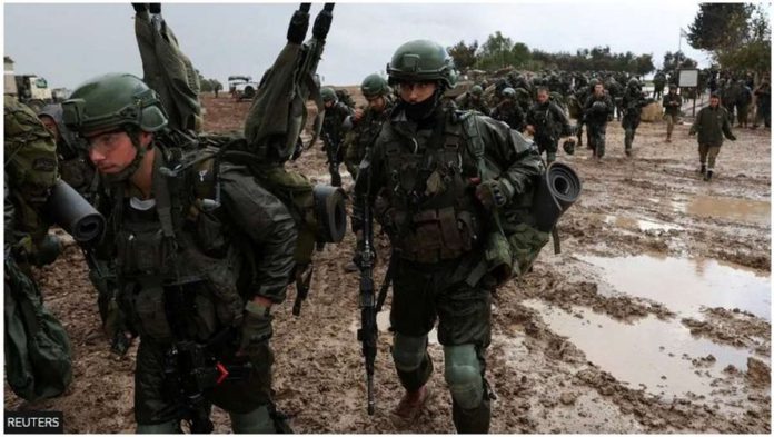 Israeli soldiers prepare to enter the Gaza Strip, near the Israel-Gaza perimeter fence. REUTERS