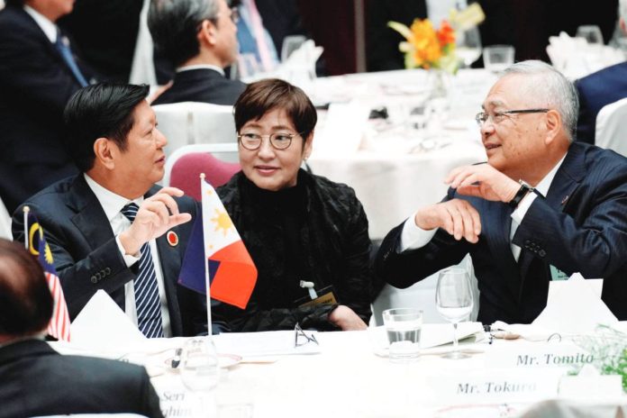 President Ferdinand Marcos Jr. speaks with Tetsuro Tomita, chair of the Board of Councillors of Keidanren (Japan Business Federation), at the 50th anniversary of the Asean-Japan Friendship and Cooperation luncheon meeting in Tokyo, Japan, on Dec. 18, 2023. REUTERS PHOTO