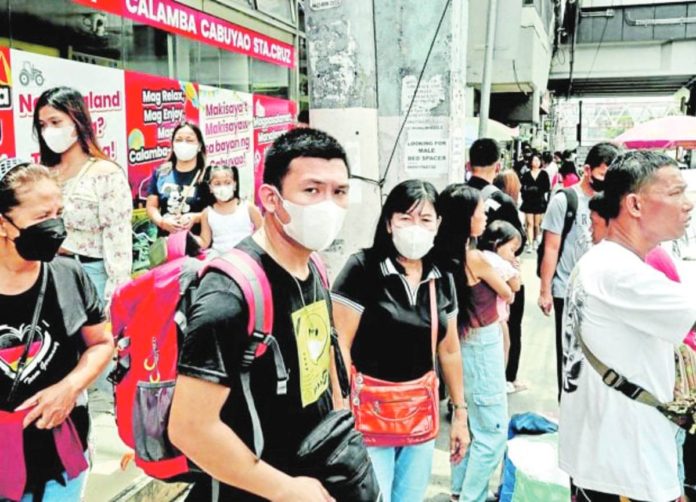 Commuters still opt to wear facemasks as protection from COVID-19 despite the recent lifting of the public health emergency. PHILIPPINE DAILY INQUIRER, RICHARD A. REYES