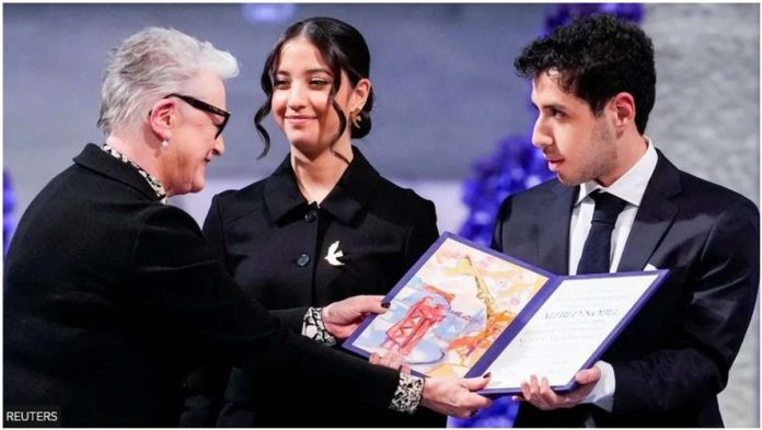 Leader of the Nobel Committee Berit Reiss-Andersen presents Ali and Kiana Rahmani, children of Narges Mohammadi, an imprisoned Iranian human rights activist, with the Nobel Peace Prize 2023, as they accept the award on behalf of their mother at Oslo City Hall, Norway on Dec. 10, 2023. REUTERS