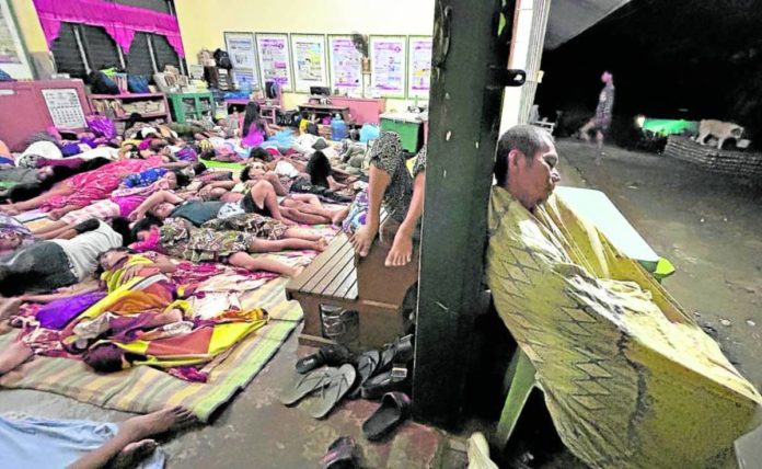 Residents of Hinatuan town in Surigao del Sur spend the night in public spaces, like school grounds and their village chapel, following the magnitude 7.4 earthquake on Dec. 2, 2023, for fear that their houses will give way from aftershocks while they are asleep. PHOTO BY ERWIN M. MASCARIÑAS, PHILIPPINE DAILY INQUIRER