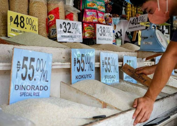 A market vendor waits for customers in front of their rice and grains store inside public market in Quezon City. GEORGE CALVELO, ABS-CBN NEWS/FILE PHOTO