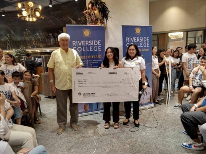 Riverside College, Inc., (RCI) President and CEO, Samuel Z. Lee awards the ceremonial check with the amount of P300,000 to Ma. Angelica Faye Z. Dela Victoria, Top 1 Licensure Examination for Physical Therapists during the Thanksgiving Lunch celebration at Vikings Luxury Buffet, SM City Bacolod.