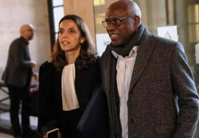 Sosthene Munyemana arrives at court with his lawyer in November. GETTY IMAGES