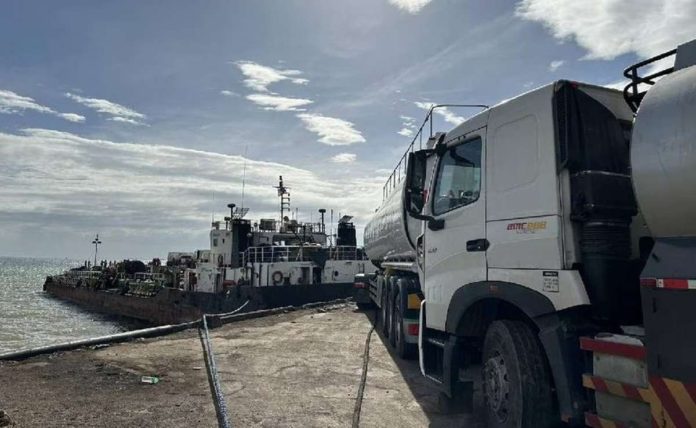 This Dec. 17, 2023 photo shows trucks and a motor tanker that personnel of the National Bureau of investigation and Bureau of Customs seized in Mariveles, Bataan. ABS-CBN NEWS/JOB MANAHAN PHOTO