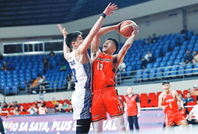 NorthPort Batang Pier’s John Amores attempts to score against the defense of TNT Tropang Giga’s Calvin Oftana. PBA PHOTO