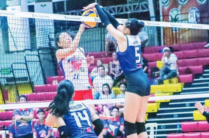 Negros ICC Blue Hawks’ Christine Joy Apan with a two-handed block against a San Juan Lady Knights Go For Gold player. Photo courtesy of MPVA PHOTO