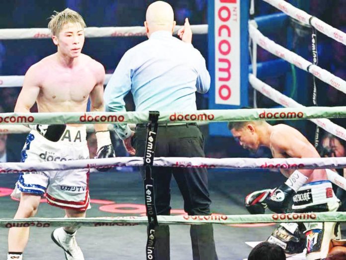 Japan's Naoya Inoue fights with Philippines’ Marlon Tapales (right) during their four-belt world super bantamweight title unification match at Tokyo's Ariake Arena on Dec. 26, 2023. PHOTO COURTESY OF KAZUHIRO NOGI / AFP