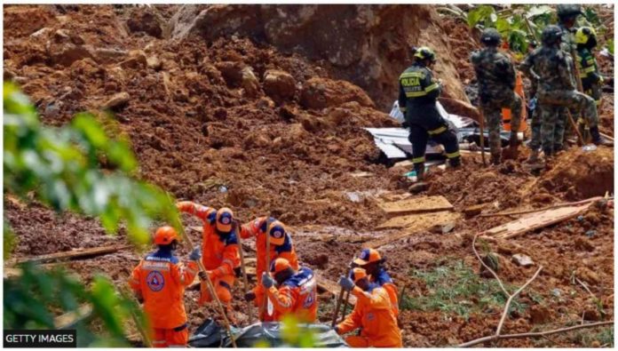 Members of a rescue team search for people trapped at the area of a landslide in the road between Quibdo and Medellin, Choco department, Colombia on Jan. 13, 2024. GETTY IMAGES