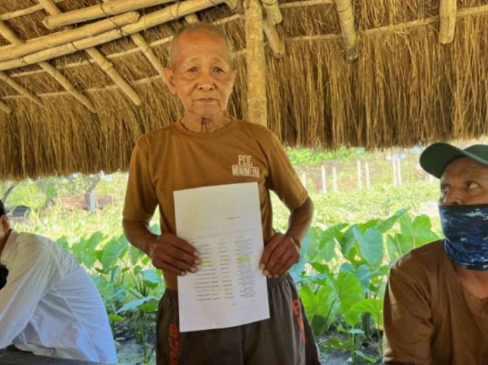 A downcast Gerardo “Tatay Gerry” Dela Peña holds the Bureau of Pardons and Parole list at the New Bilibid Prison Minimum Security Compound on January 15, 2024. PHOTO AND CAPTION COURTESY OF KAPATID