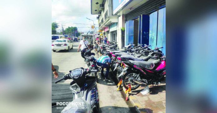 Motorcycles from a retail establishment illegally occupy the sidewalk in front of a high school in Bacolod City. The local traffic authority deemed the obstruction a hazard. JOSE ANTONIO ROBELLO PHOTO