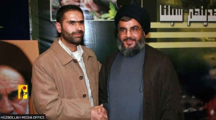 This hand-out image from the Hezbollah Media Office shows Wissam Tawil (left), a commander killed in a suspected Israeli strike in southern Lebanon on Jan. 8, 2024, shaking hands with leader Hassan Nasrallah. HEZBOLLAH MEDIA OFFICE