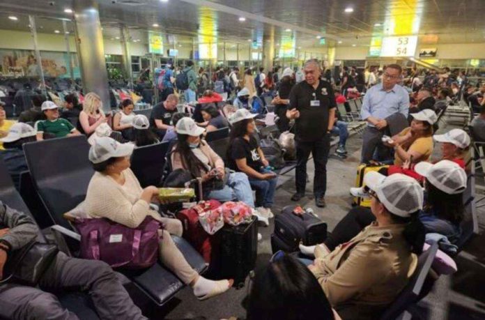 Ambassador Alfonso Ferdinand Ver and Consul General Marford Angeles of Embassy of the Philippines in United Arab Emirates meet 39 overseas Filipino workers (OFWs) from Israel while in transit at Abu Dhabi International Airport. They comprise the 7th batch of OFWs to return to the Philippines since Israel-Hamas conflict broke out in early October. File photo from DEPARTMENT OF MIGRANT WORKERS Facebook page