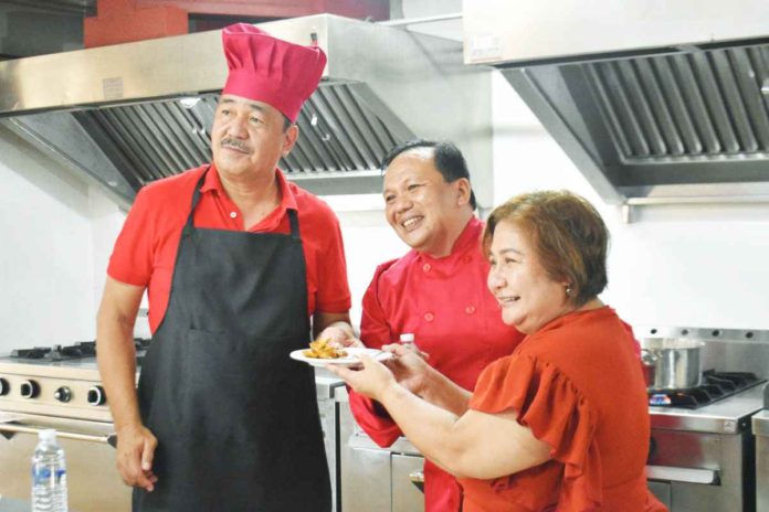 Dr. J. Prospero E. de Vera III (left), the Commission on Higher Education (CHED) chairman, together with Dr. Pablo S. Crespo Jr. (center), University of Antique president, and Atty. Lily Freida M. Milla, OIC deputy executive director and director of International Affairs Services of CHED, try the Hot and Cold kitchen facility of the university.