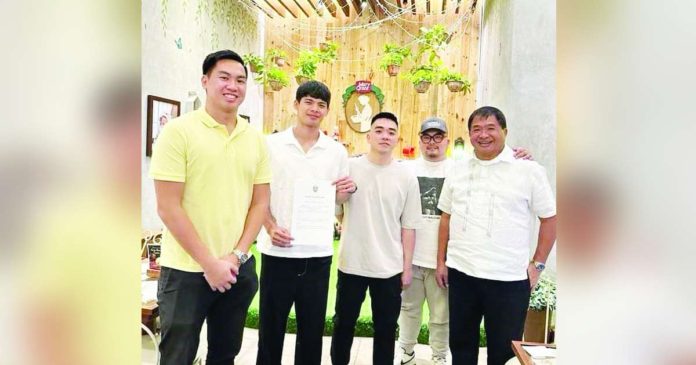 Crispin John Cansino (second from left) formally signs his contract with Iloilo United Royals on Friday. PHOTO COURTESY OF ILOILO UNITED ROYALS