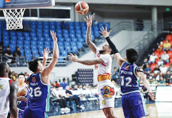 Rain or Shine Elasto Painters’ Nicholas Demusis attempts a floater against the defense of Converge FiberXers’ Bryan Santos. PBA PHOTO