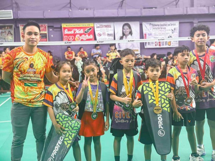 The Barotac Viejo Civet Shuttlers Academy players with coach Alain Rhey D. Balderas (leftmost)