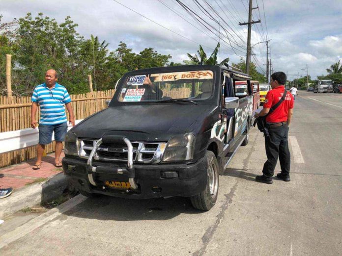 Personnel of the Iloilo City Traffic Management Unit distribute stickers to consolidated public utility jeepneys. ILOILO CITY TRAFFIC MANAGEMENT UNIT PHOTO