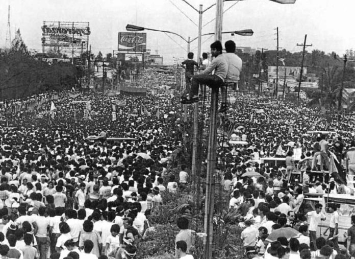 Thousands of people jam Edsa on Feb. 23, 1986. The 1986 Edsa People Power Revolution served as a “beacon of hope” for millions, promising freedom, democracy, and equality. It also offered a new opportunity for improved Filipino workers’ rights. But some of the bright possibilities brought by the world-renowned bloodless uprising that led to the ouster of a dictator remained a promise 38 years later, according to labor leaders. PEOPLE POWER BOOK, THE PHILIPPINE REVOLUTION OF 1986