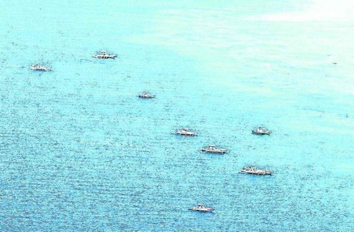 Filipino fishing boats conduct fishing activity in Bajo de Masicloc. INQUIRER FILE PHOTO / GRIG C. MONTEGRANDE