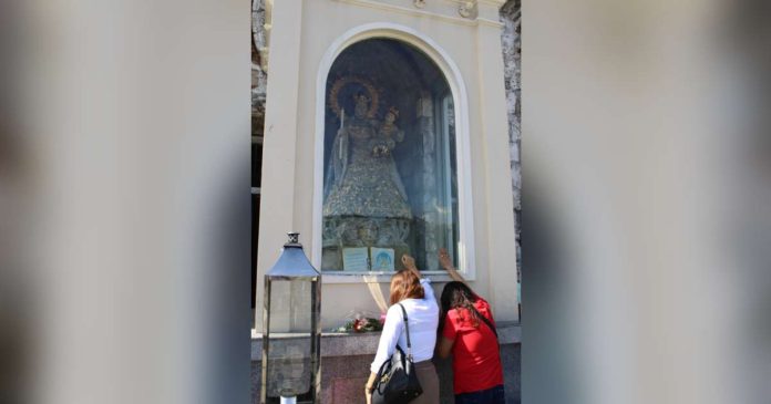 Thousands of devotees from across Western Visayas are expected to gather at the Jaro Metropolitan Cathedral today, Feb. 2, for the feast of Nuestra Señora de la Candelaria. Photo shows two devotees offering prayers to the Marian image of the Candelaria at the cathedral’s balcony on Thursday, Feb. 1. AJ PALCULLO/PN