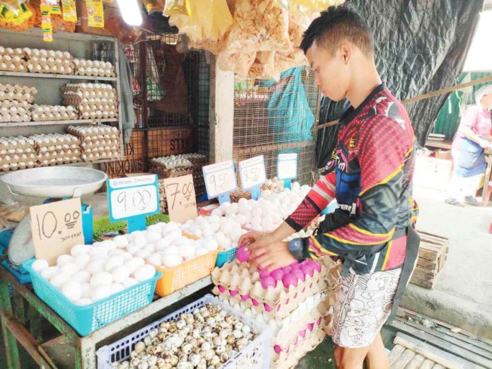 Fonderic Mate, a store attendant at the Iloilo Terminal Market, says they source their eggs from Metro Manila and Batangas. Their egg prices range from P7 to P10. AJ PALCULLO/PN