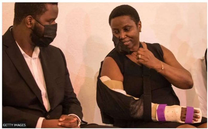 First Lady Martine Moise speaks with her son Jovenel Junior Moise during a Catholic ceremony of funeral vigil for President Jovenel Moïse at Hotel Roi Christophe, in Cap-Haitien, July 22, 2021. Martine was injured in the attack in which her husband was killed. GETTY IMAGES