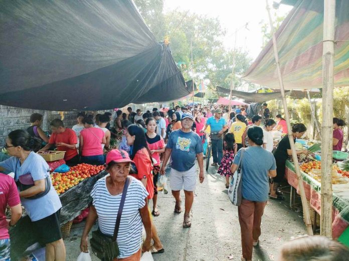 Photo shows people buying fruits and vegetables at a public market in Pavia, Iloilo. AJ PALCULLO/PN